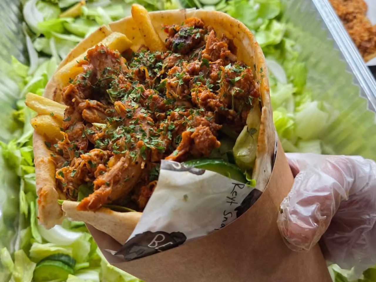 A freshly rolled street food wrap filled with grilled steak and fresh salad, ideal for VIP talent riders and crew feeding in TV & film catering.