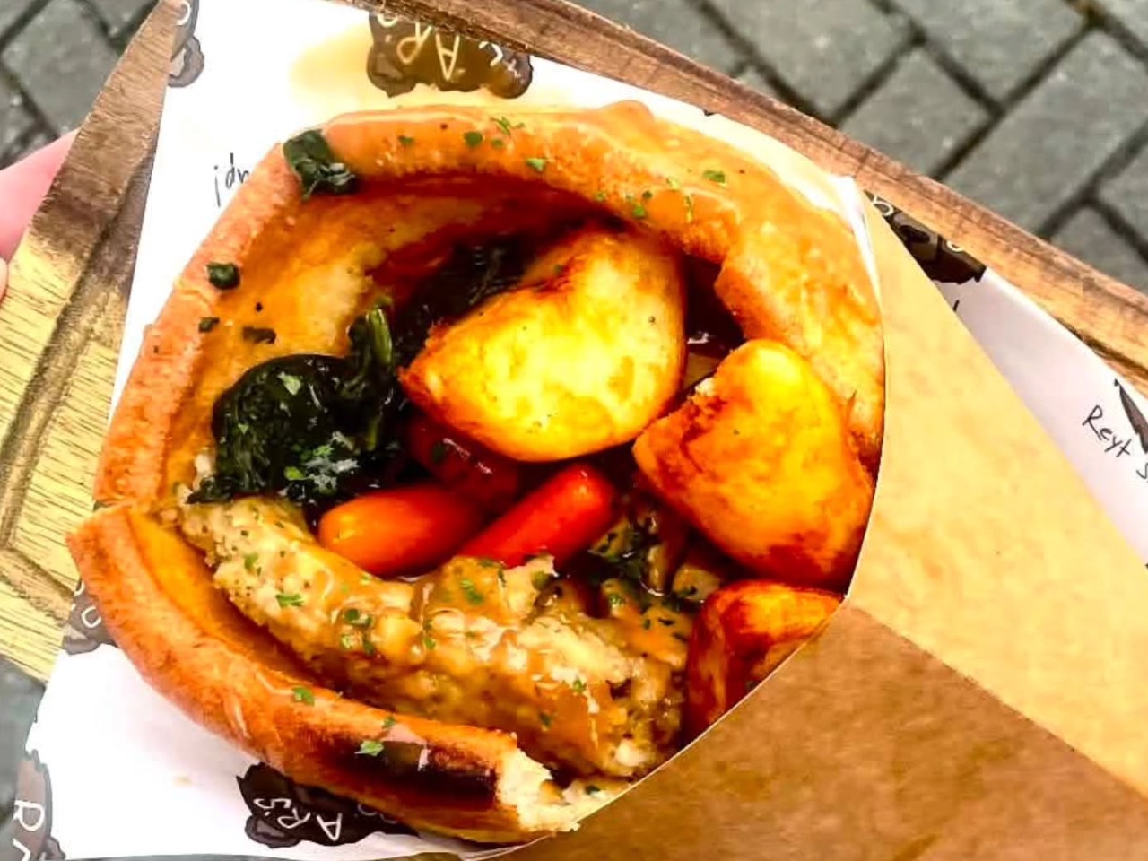A giant Yorkshire pudding wrap packed with tender roast beef, stuffing and rich gravy, served hot for workplace canteen catering.